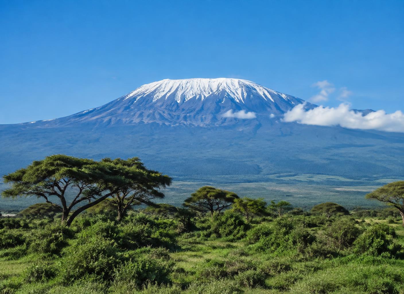 The snow-capped peak of Mount Kilimanjaro rising above the clouds